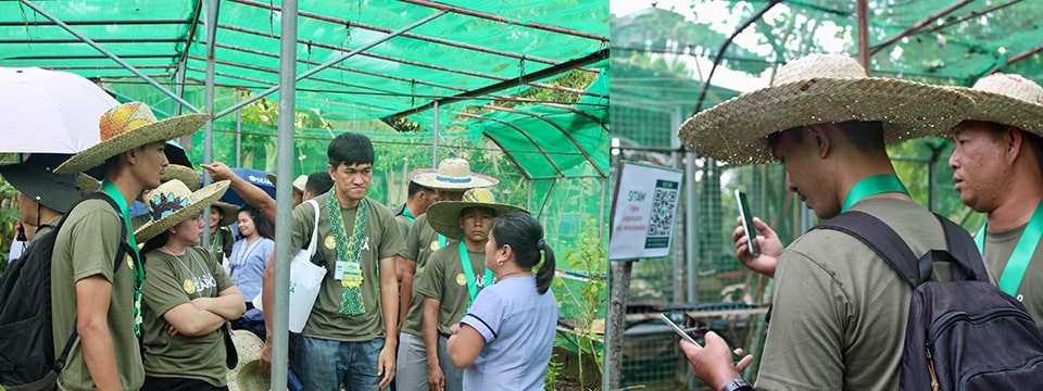 (L-R) A teacher from Siniloan Integrated National High School conducted a guided tour. Participants scan a QR code to access detailed information about the vegetables.